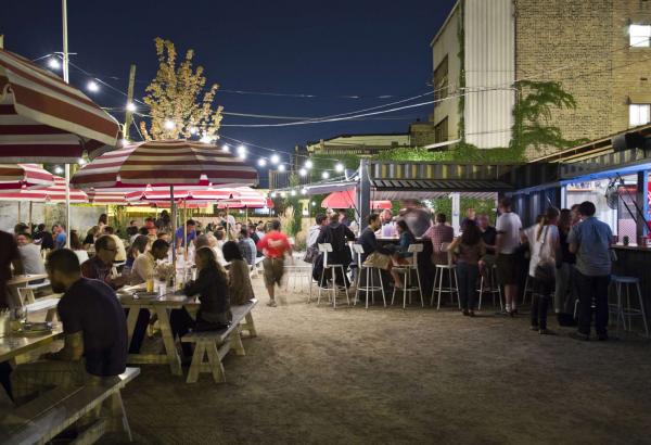 Patrons dining outdoors in the evening