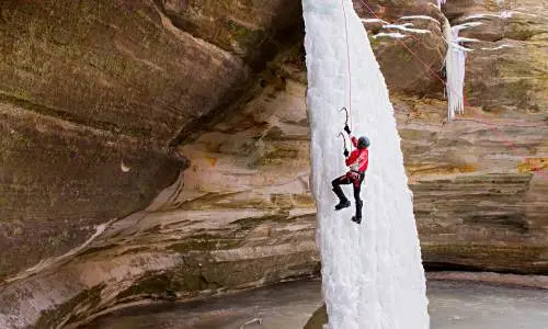 Person climbing ice waterfall